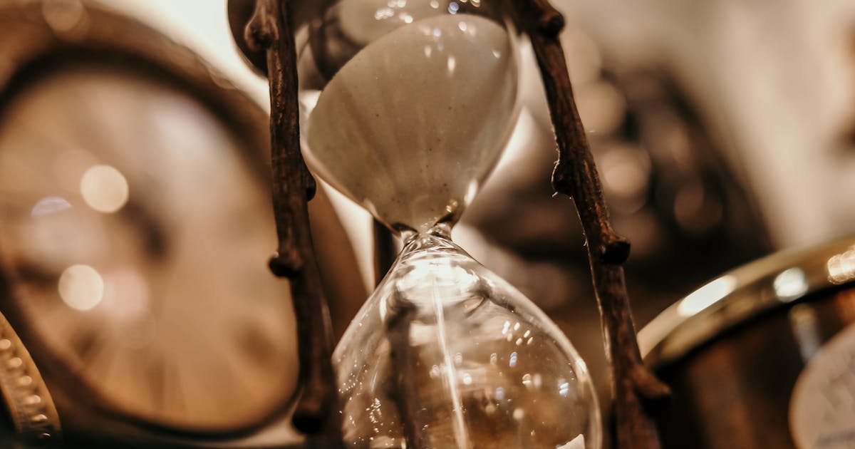 Hourglass with sand flowing, representing the time-sensitive nature of aged lead consent