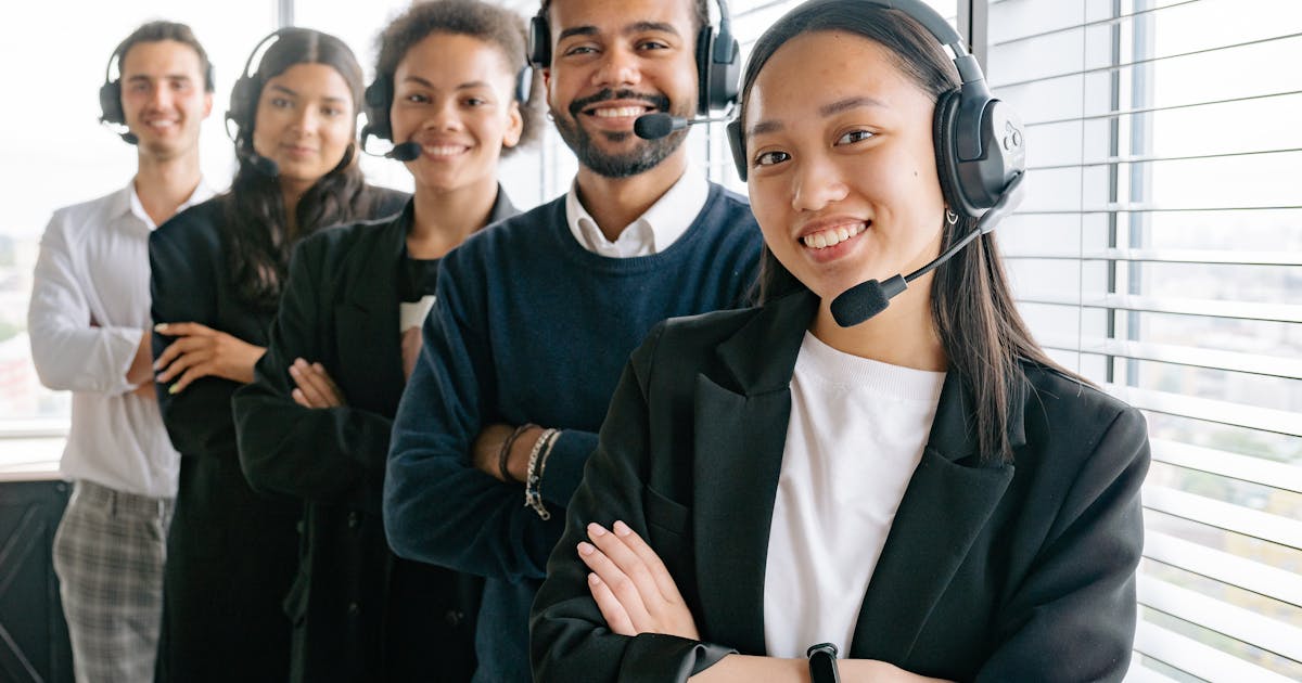 Diverse call center team wearing headsets in a professional office environment