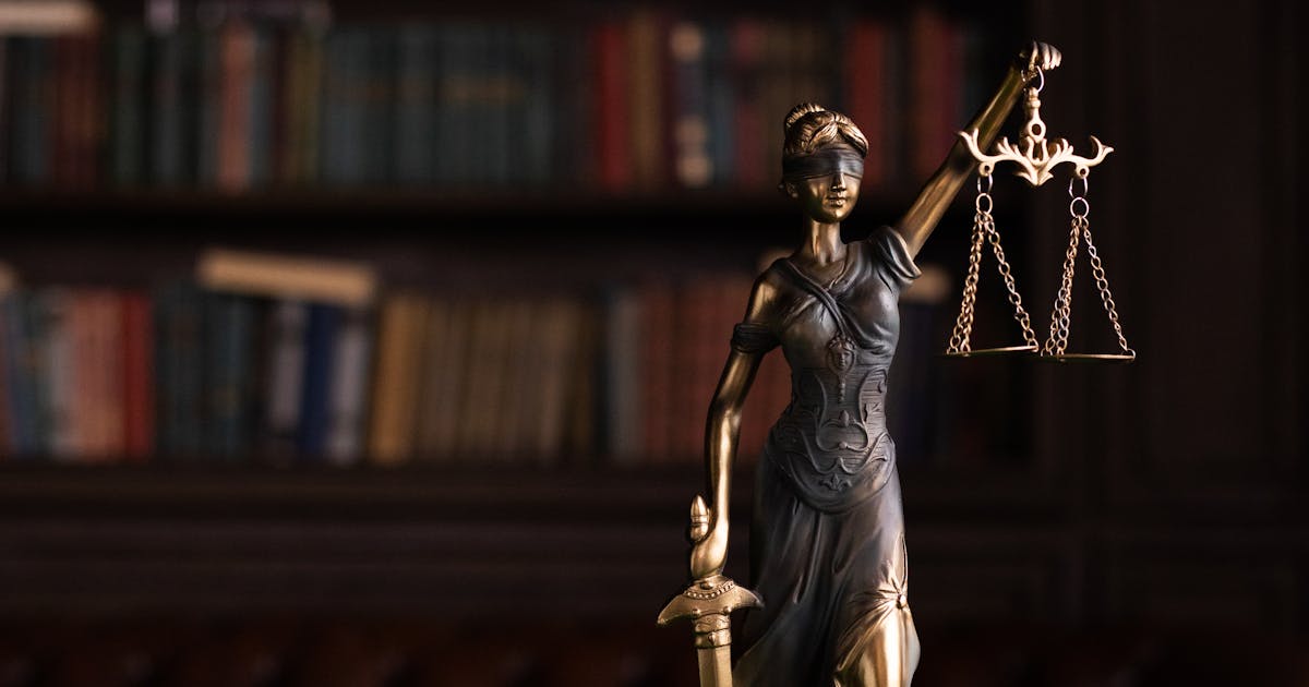 Lady Justice statue and gavel representing class action litigation